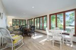 The sun room has several seating options to relax, enjoy a meal, or even play a game